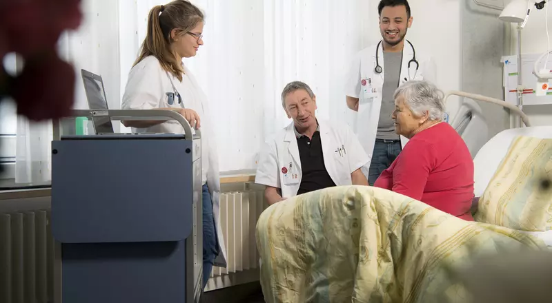 Ein Ärzteteam unterhält sich mit einer Patientin